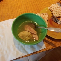 Chicken soup with matzo ball and side of charoset with matzo cracker